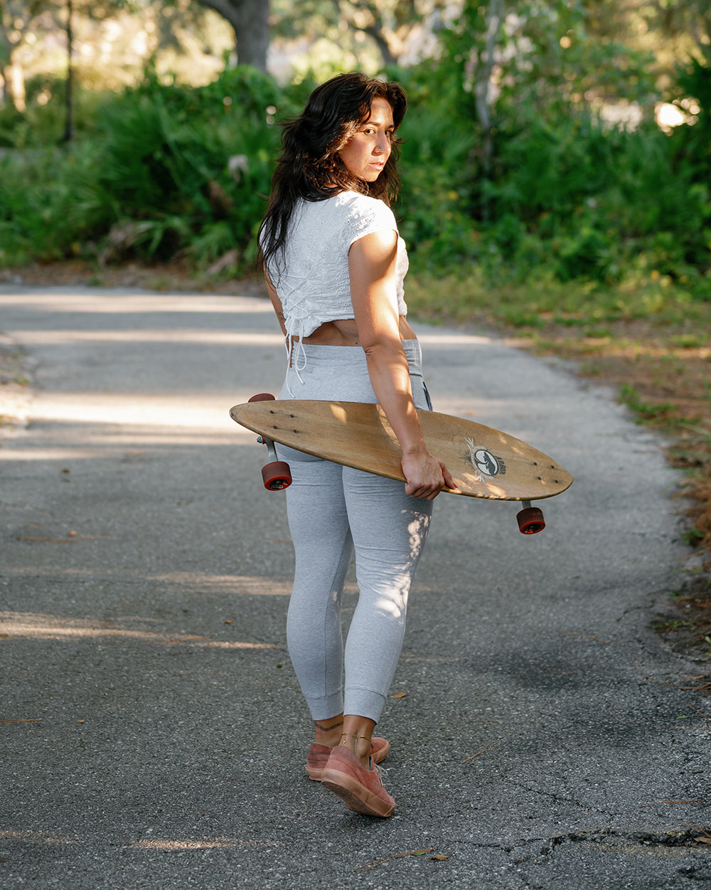 holding skateboard in #color_ash